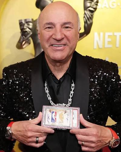 Kevin O'Leary holding the $12.93 million Jordan/Kobe dual logoman card